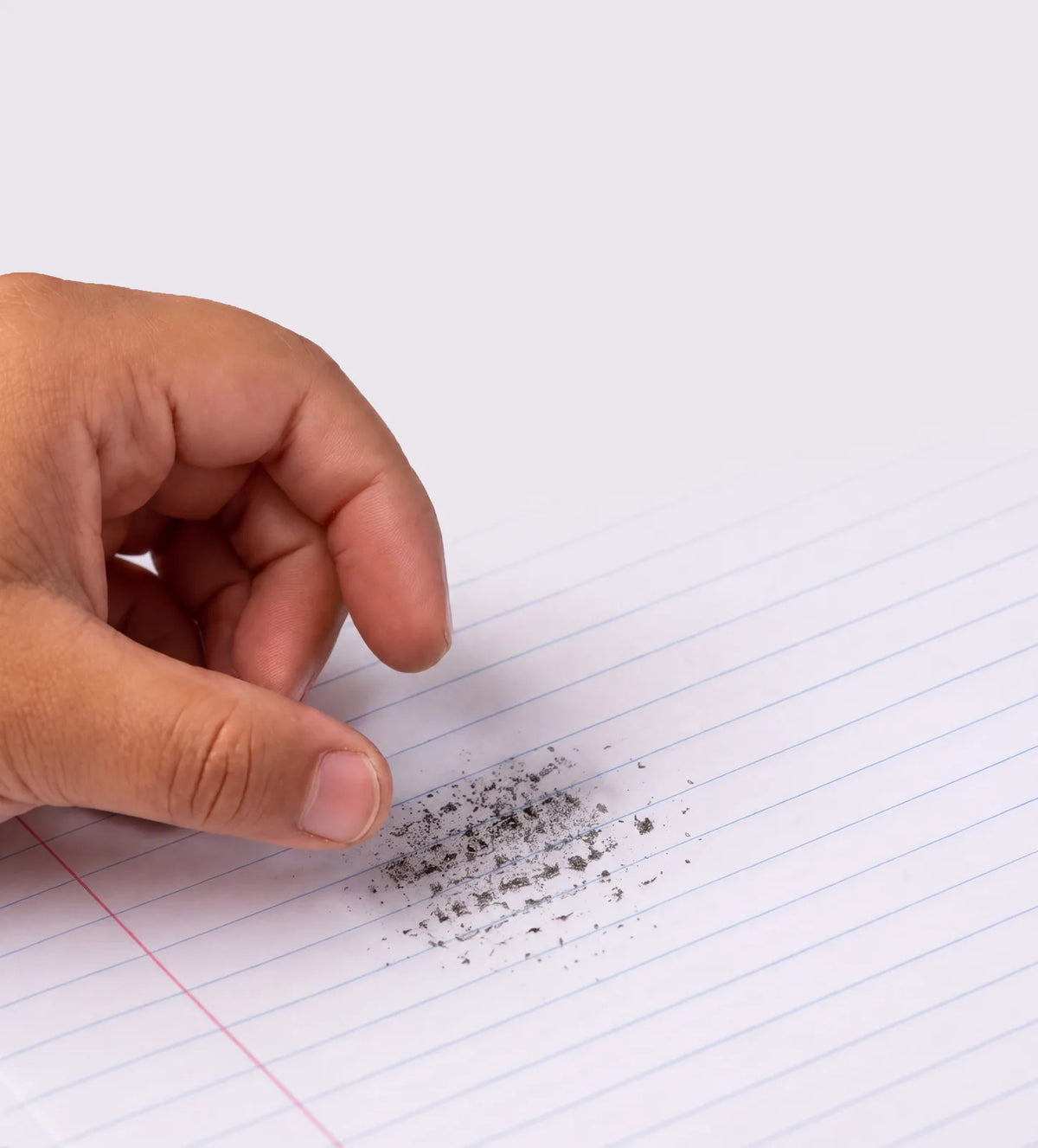 A hand holding a Schnerds eraser on a notebook page